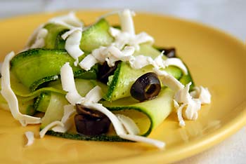 Zucchini ribbon salad with black olives and soy cheese