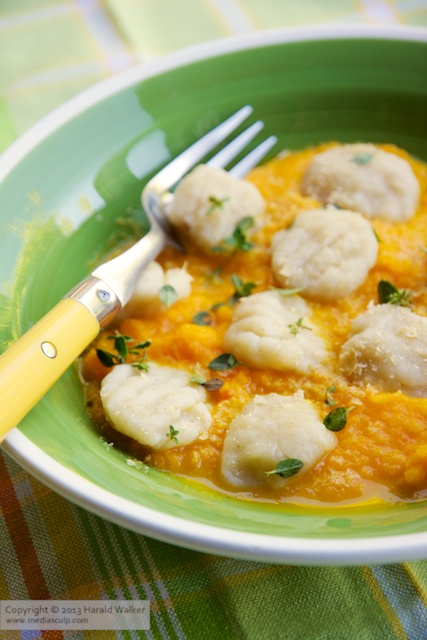 Celery root gnocchi with apple carrot sauce - click here to license this photo from Stocksy