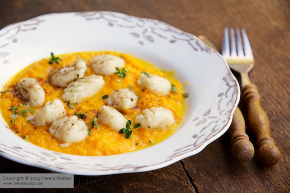 Celery root gnocchi with apple carrot sauce - Click here to license this photo from Stocksy